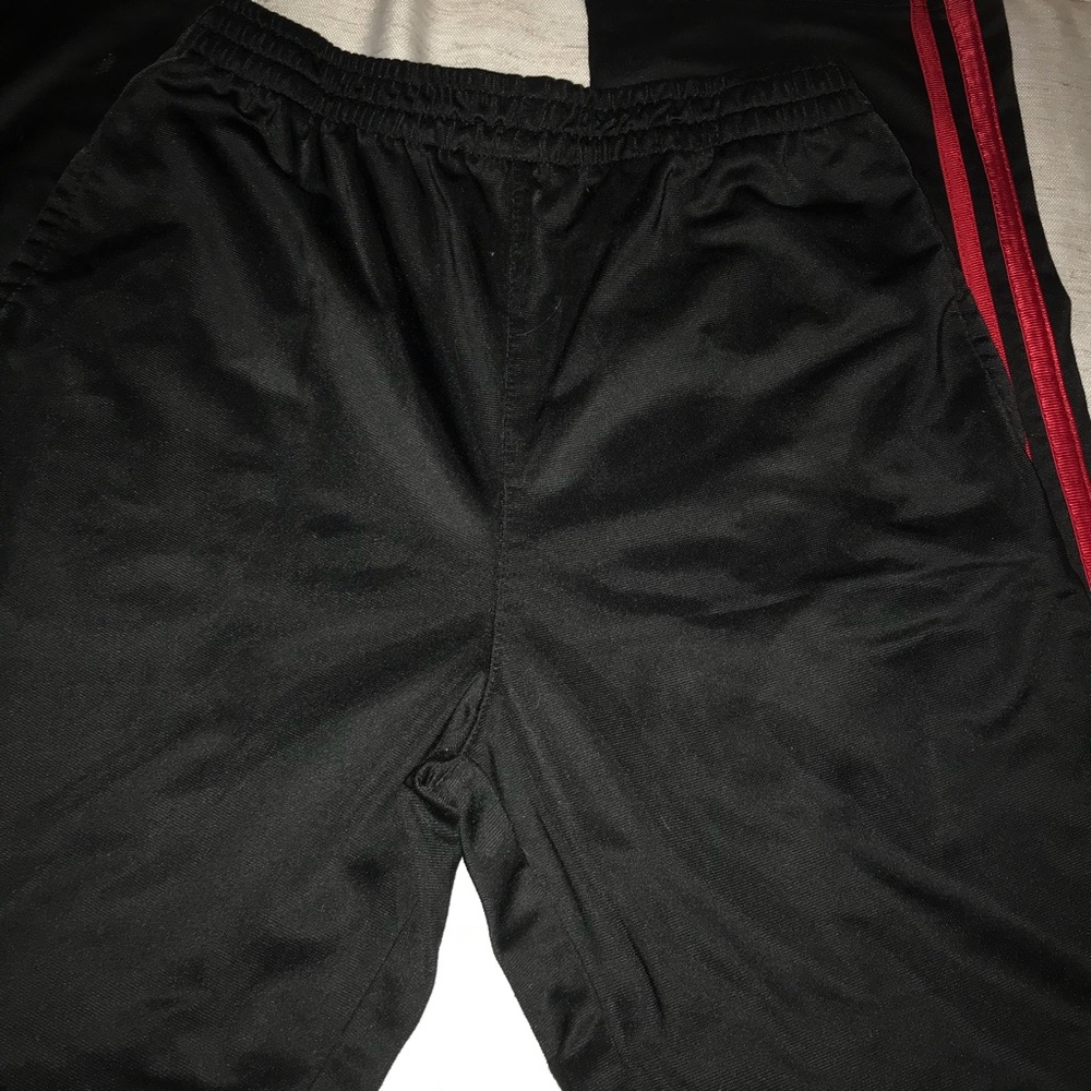 Black and red warm up pants